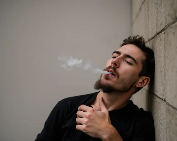 Man Against Wall Smoking Cigarette Image